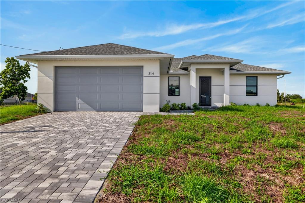 Contemporary single-story residence featuring a smooth stucco exterior and a dark gray asphalt shingle roof