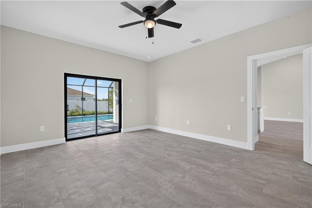 Modern kitchen featuring white shaker cabinetry, stainless steel appliances, and marble-look countertops