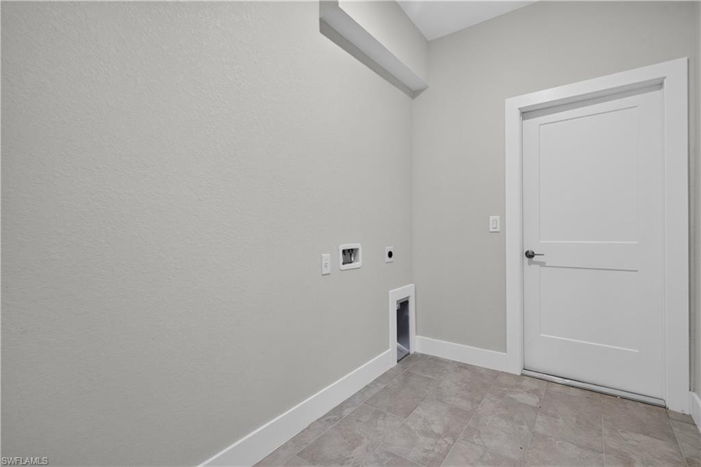 Contemporary bathroom featuring a white vanity with an integrated rectangular sink, a white countertop with gray veining, and a framed mirror