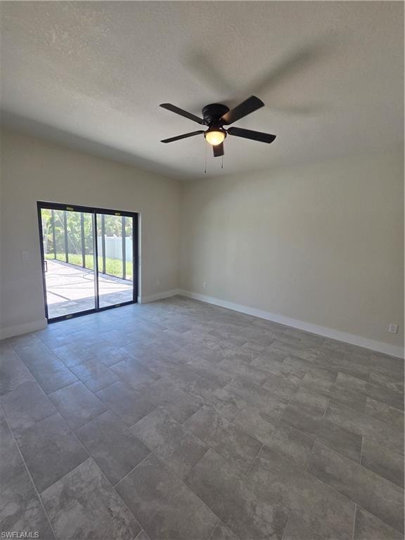 Spacious room featuring gray rectangular tile flooring, clean neutral walls, and a contemporary ceiling fan with integrated lighting