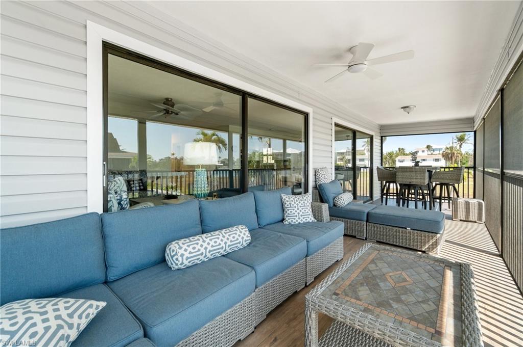 Sunroom with ceiling fan, outdoor dining space, and an outdoor hangout area