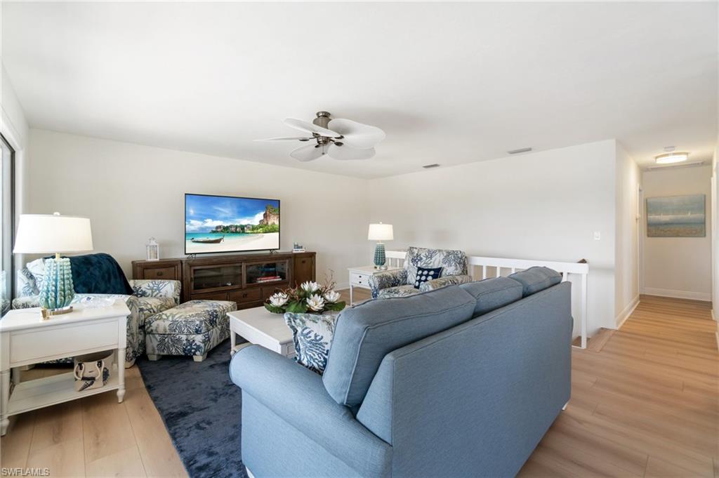Living room featuring light wood-style flooring and ceiling fan