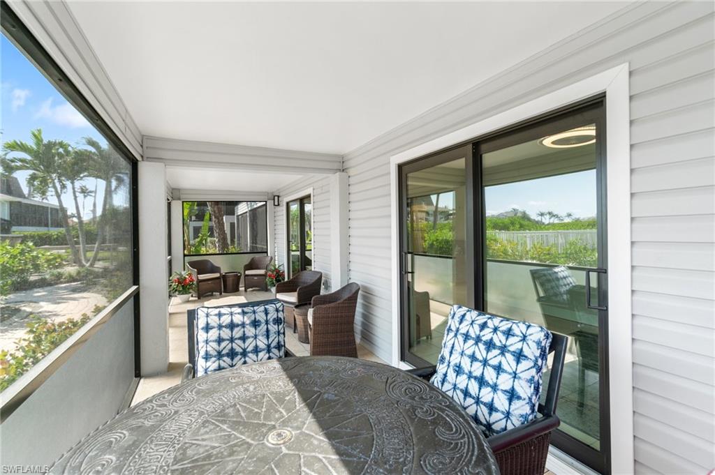 Sunroom with outdoor dining space and an outdoor hangout area