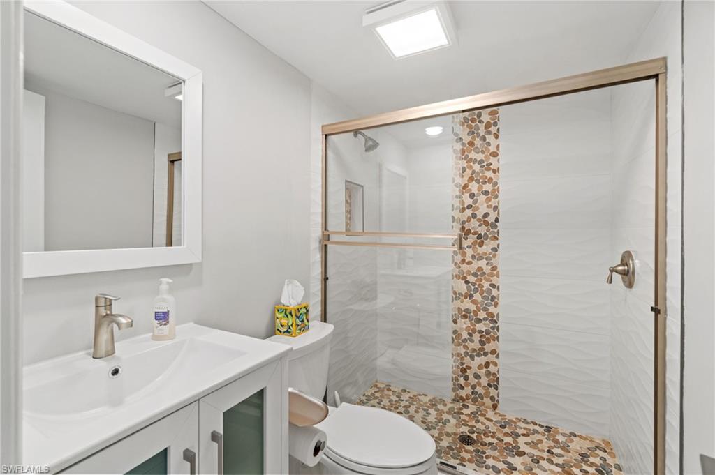 Full bathroom with a stall shower and vanity