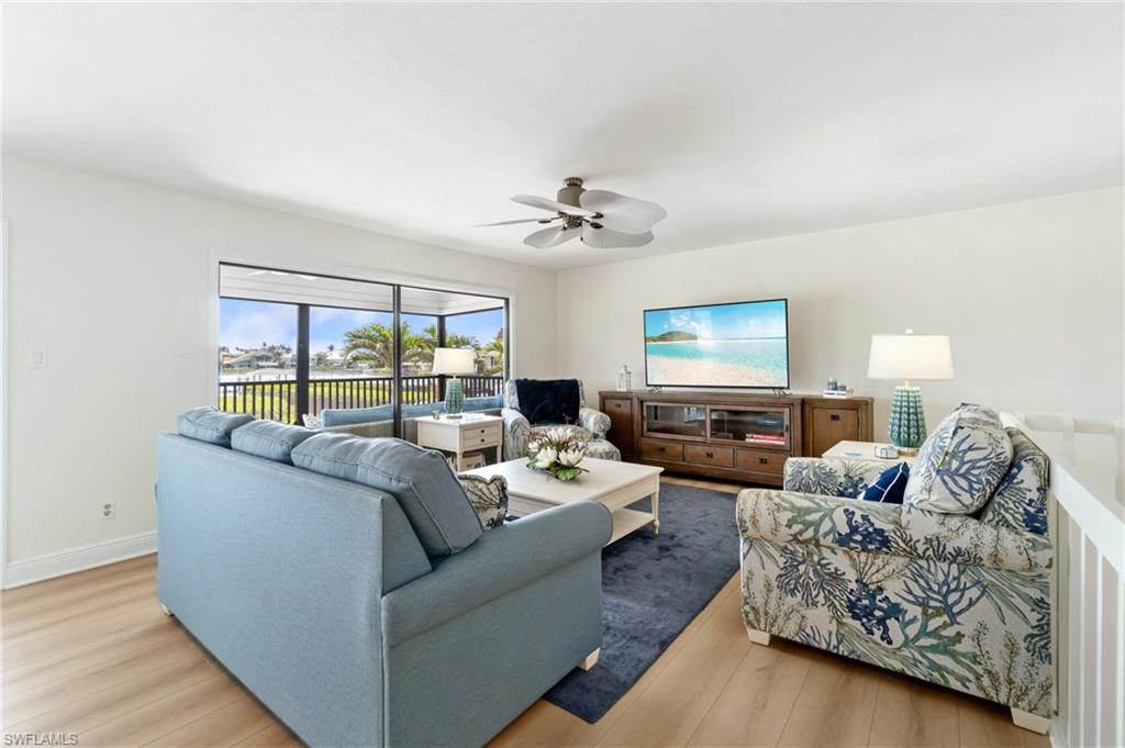Living area featuring light wood-style floors and a ceiling fan