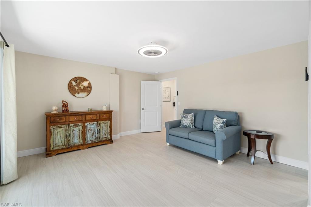 Sitting room featuring baseboards and light wood-style floors