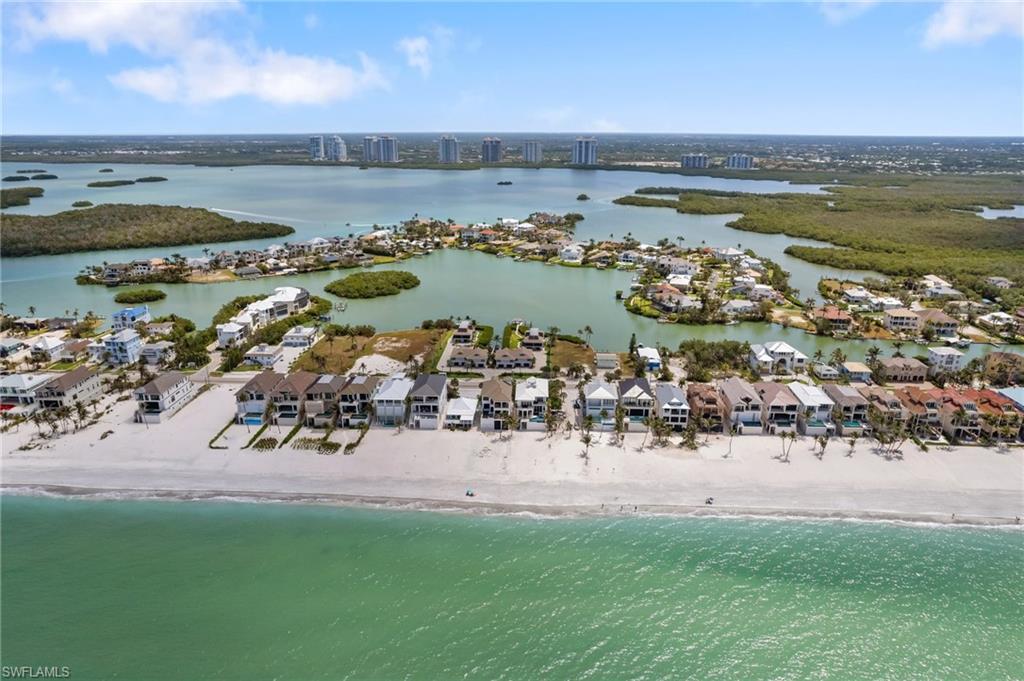 View of urban area featuring nearby suburban area and waterfront with a beach