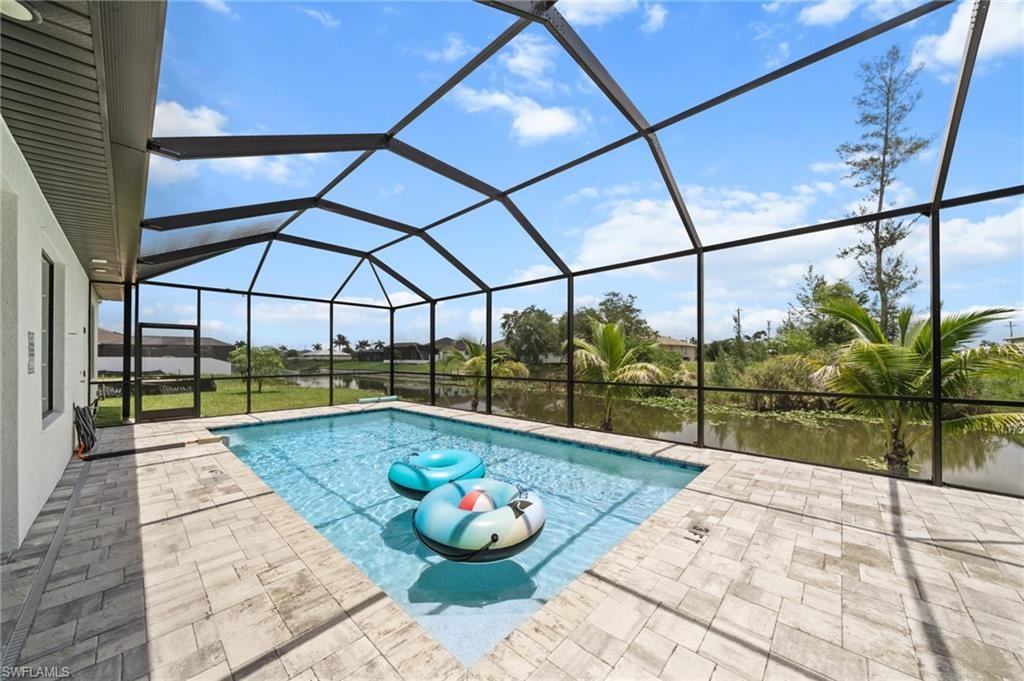 Swimming pool featuring a patio area and a lanai