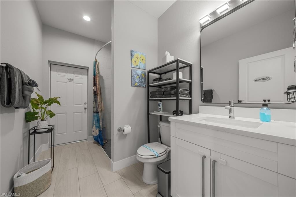 Full bathroom with vanity and curtained shower