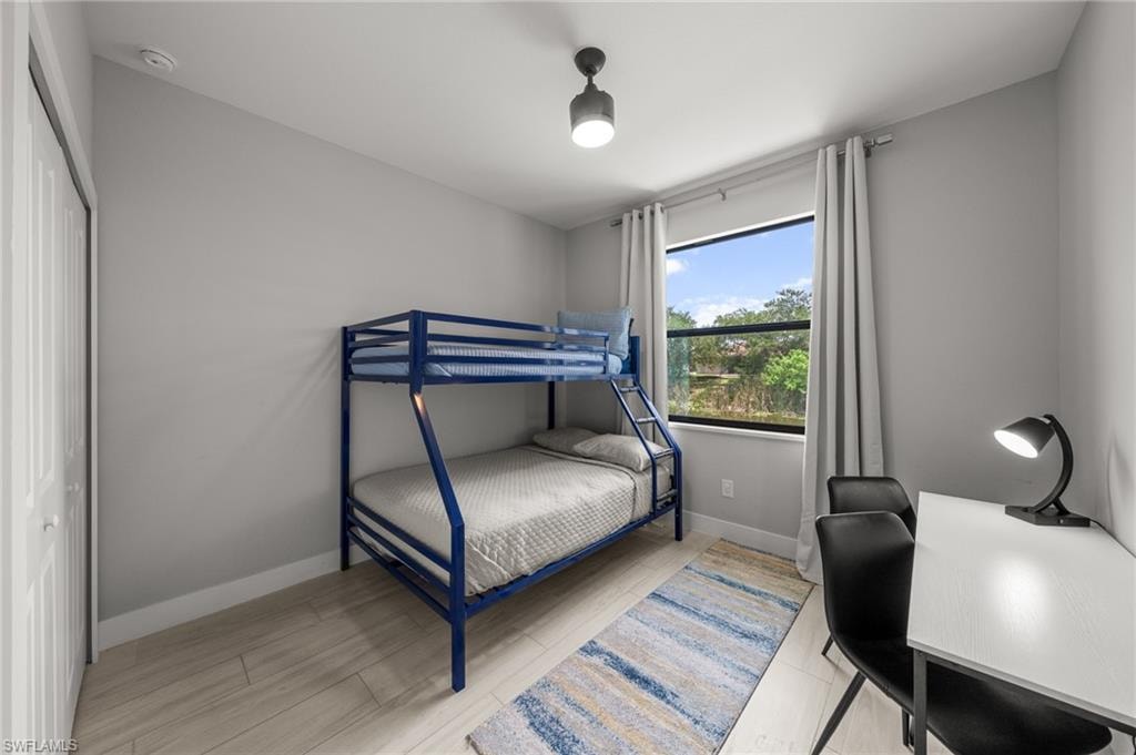 Bedroom featuring baseboards and wood finished floors