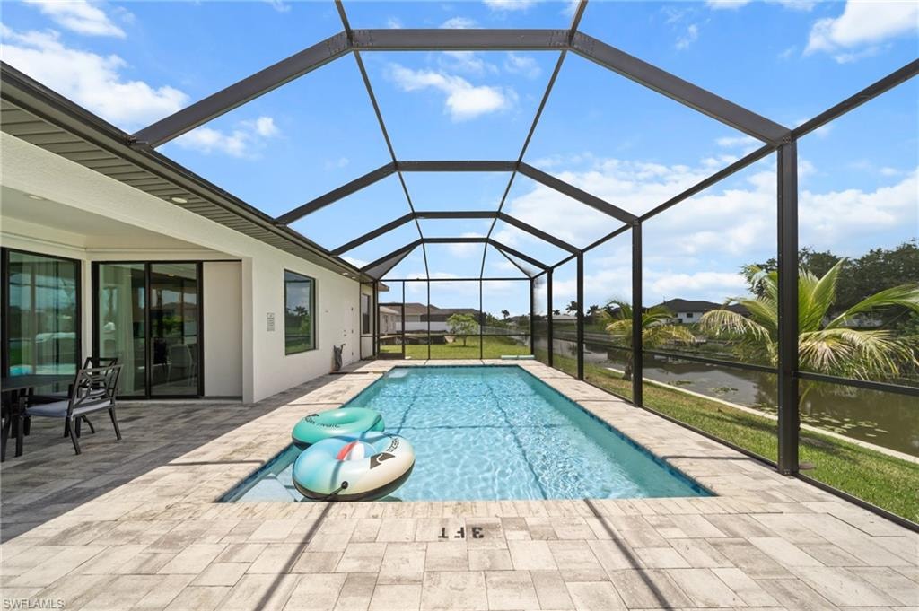 Outdoor pool with a patio area and a lanai