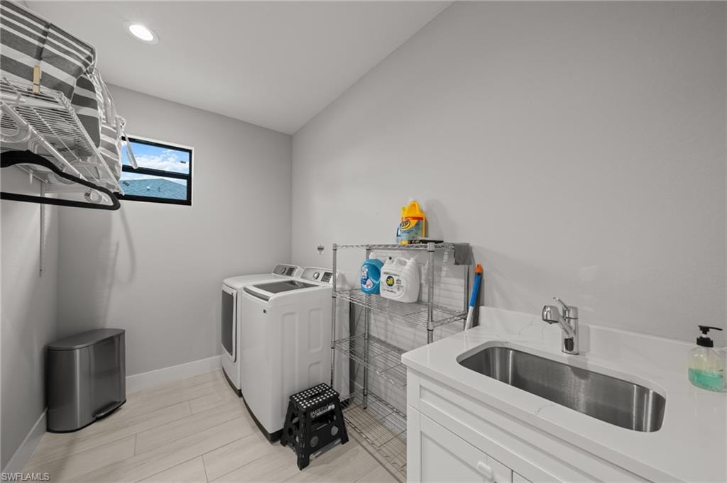 Laundry room with washer and clothes dryer and recessed lighting