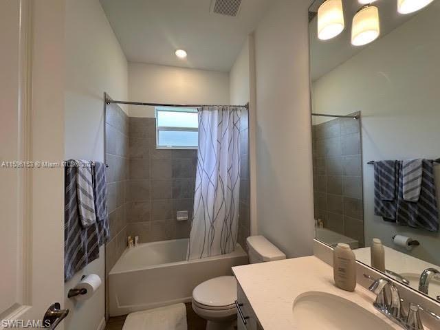Shared Full bathroom with the between 3rd and 4th bedroom featuring toilet, shower / bath combination with curtain, and vanity