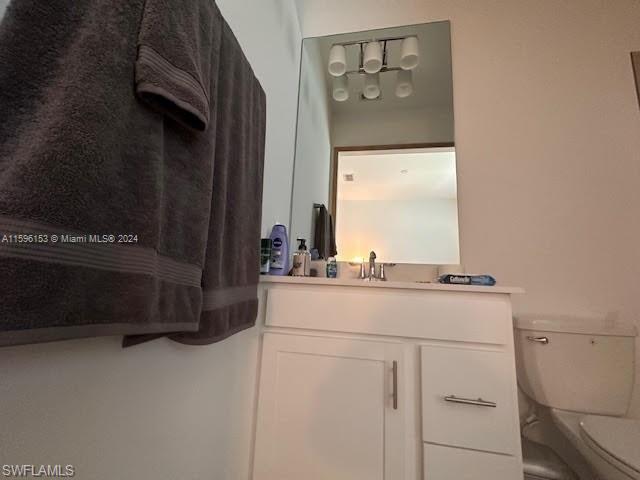 Shared Full bathroom with the between 3rd and 4th bedroom featuring toilet, shower / bath combination with curtain, and vanity