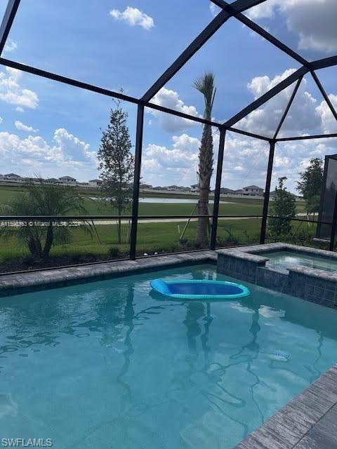 View of pool featuring a lanai