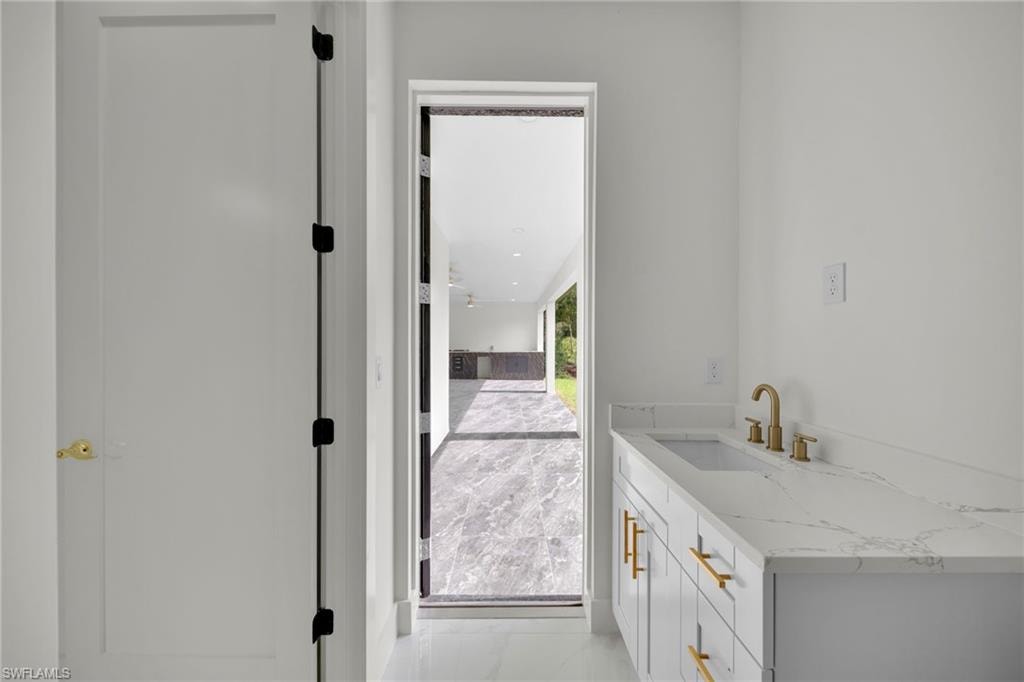 Bathroom with marble finish floors and vanity