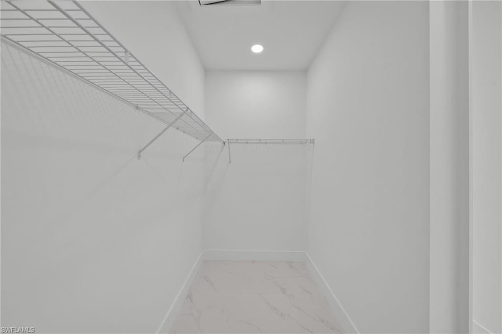 Spacious closet with marble finish flooring