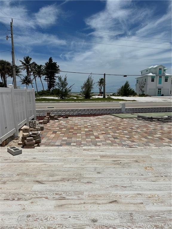 View of asphalt road with sidewalks and curbs