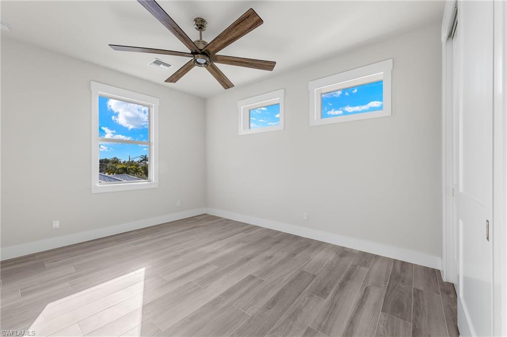 Unfurnished room featuring ceiling fan and light wood-type flooring