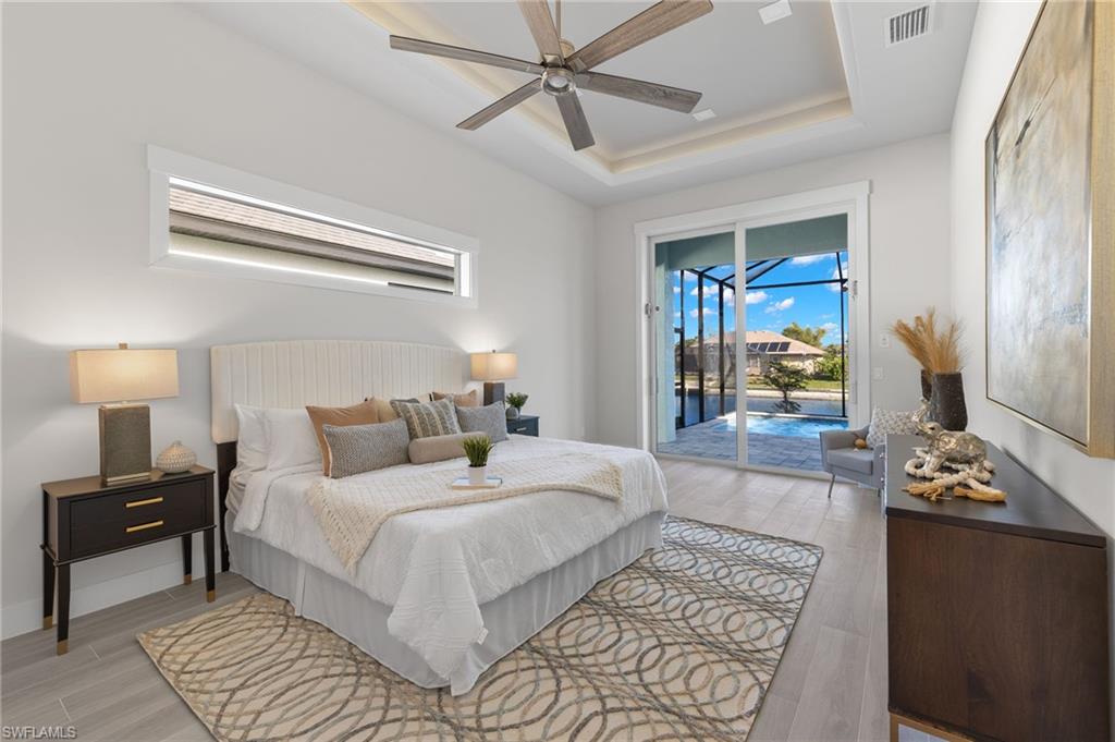 access to outside, ceiling fan, and a tray ceiling