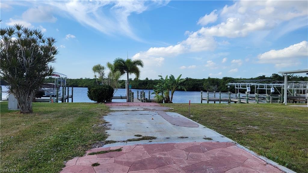 Dock with a lawn, a water view, and boat lift