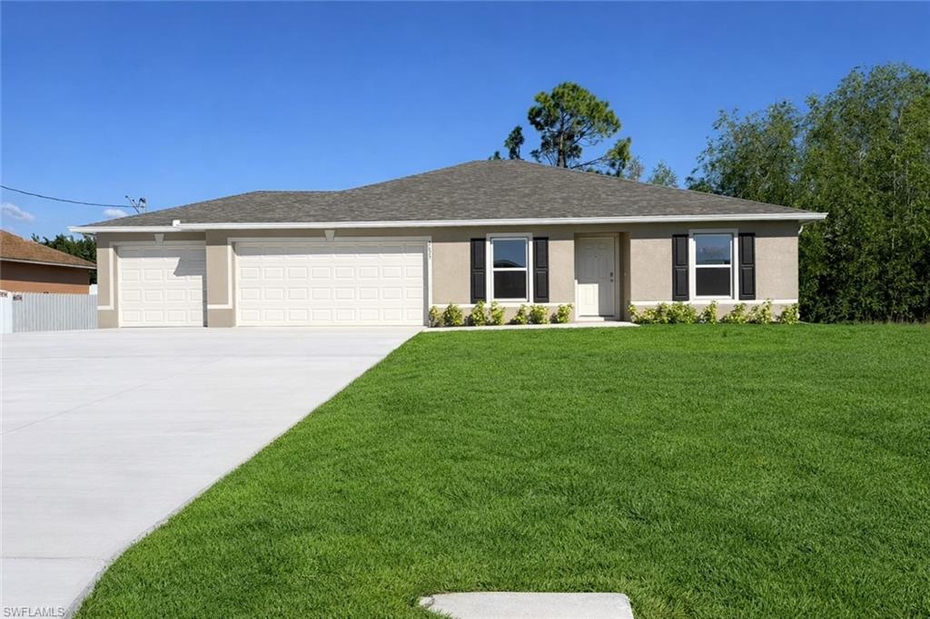 Ranch-style home with a front yard, stucco siding, an attached garage, a shingled roof, and concrete driveway