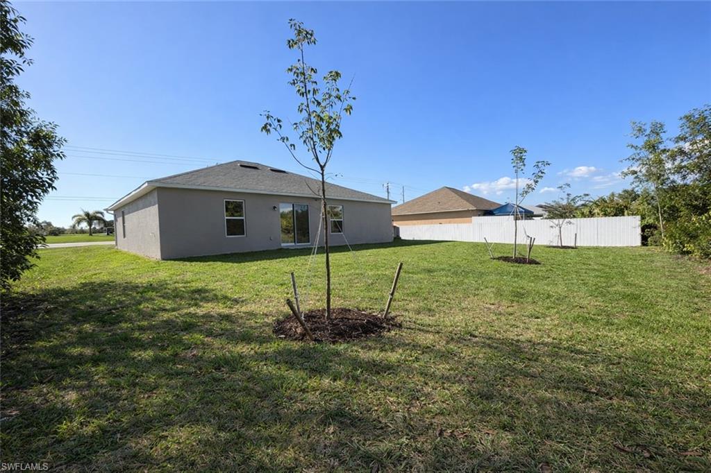 Back of house featuring stucco siding