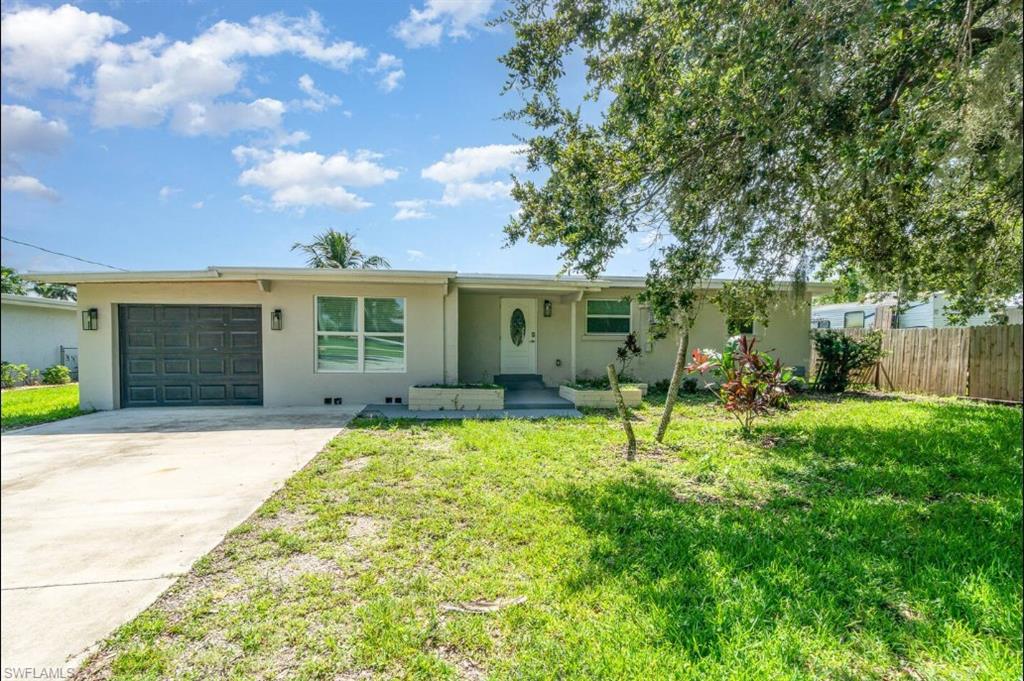 Ranch-style home with concrete driveway, an attached garage, and stucco siding