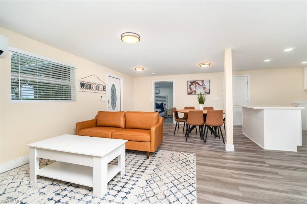 Living area with light wood-style flooring and recessed lighting