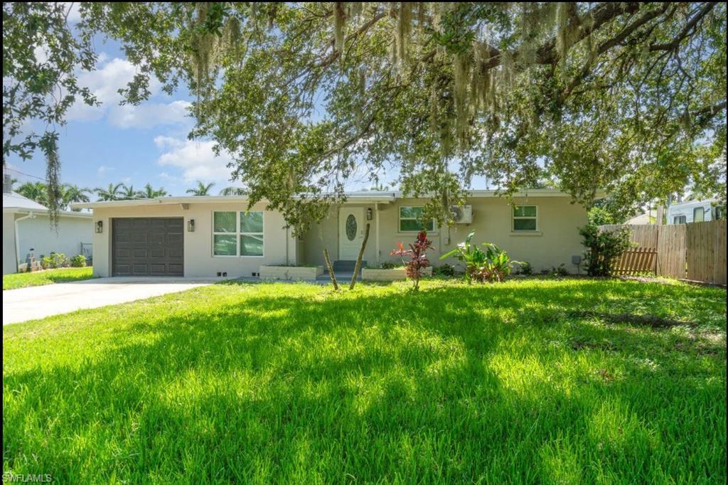 Ranch-style home featuring an attached garage, concrete driveway, and stucco siding