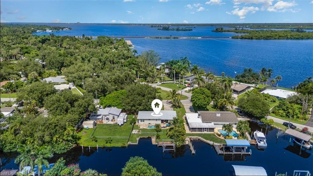 Aerial perspective of suburban area featuring a large body of water