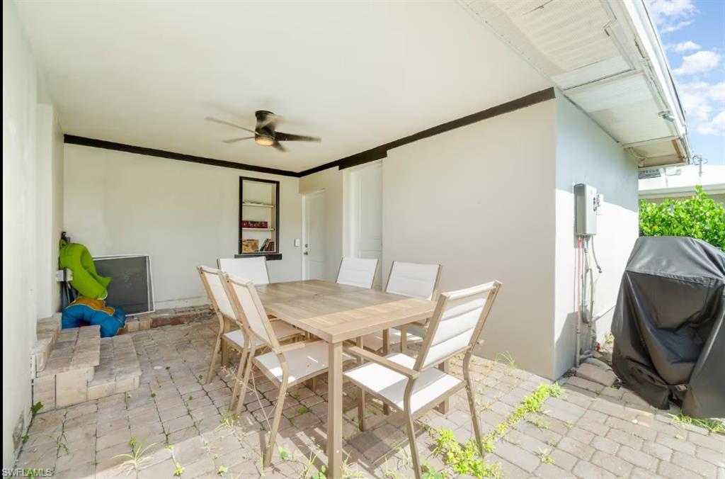 View of patio / terrace with ceiling fan, outdoor dining space, and a grill