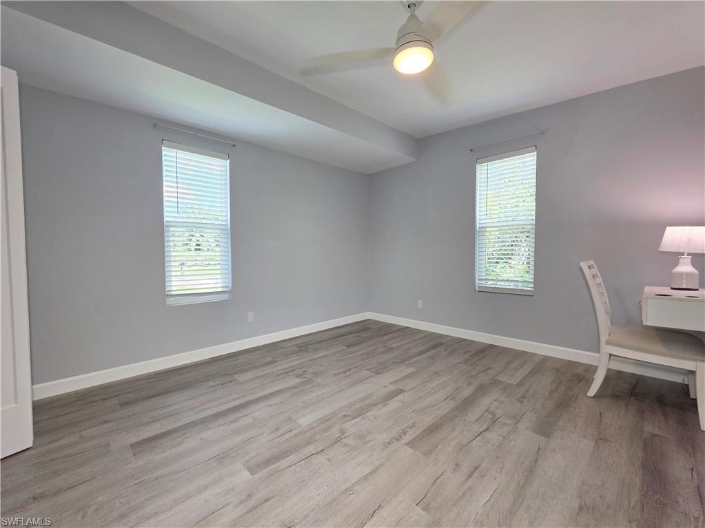 Unfurnished office featuring wood finished floors and a ceiling fan