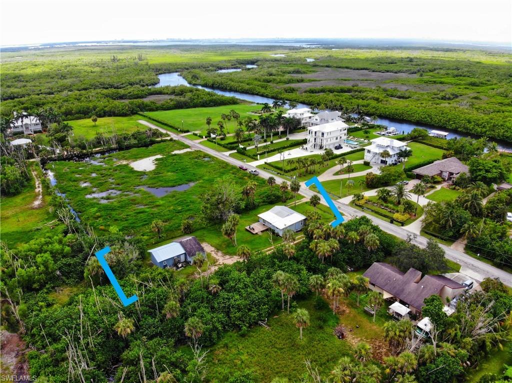 Bird's eye view of a nearby body of water and a heavily wooded area