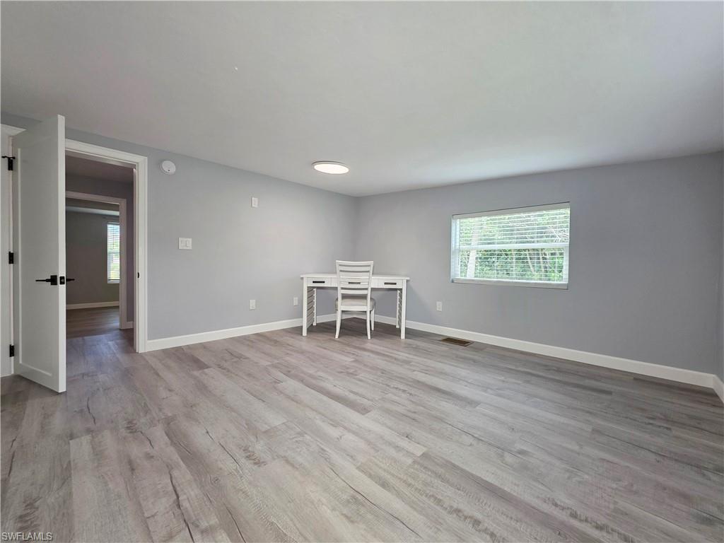 Unfurnished room featuring light wood-type flooring