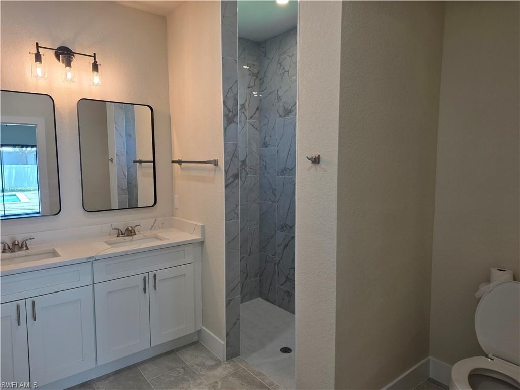 Modern bathroom featuring a dual vanity with white shaker-style cabinetry, white countertops, and contemporary rectangular mirrors