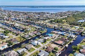 Aerial overview of property's location with a nearby body of water
