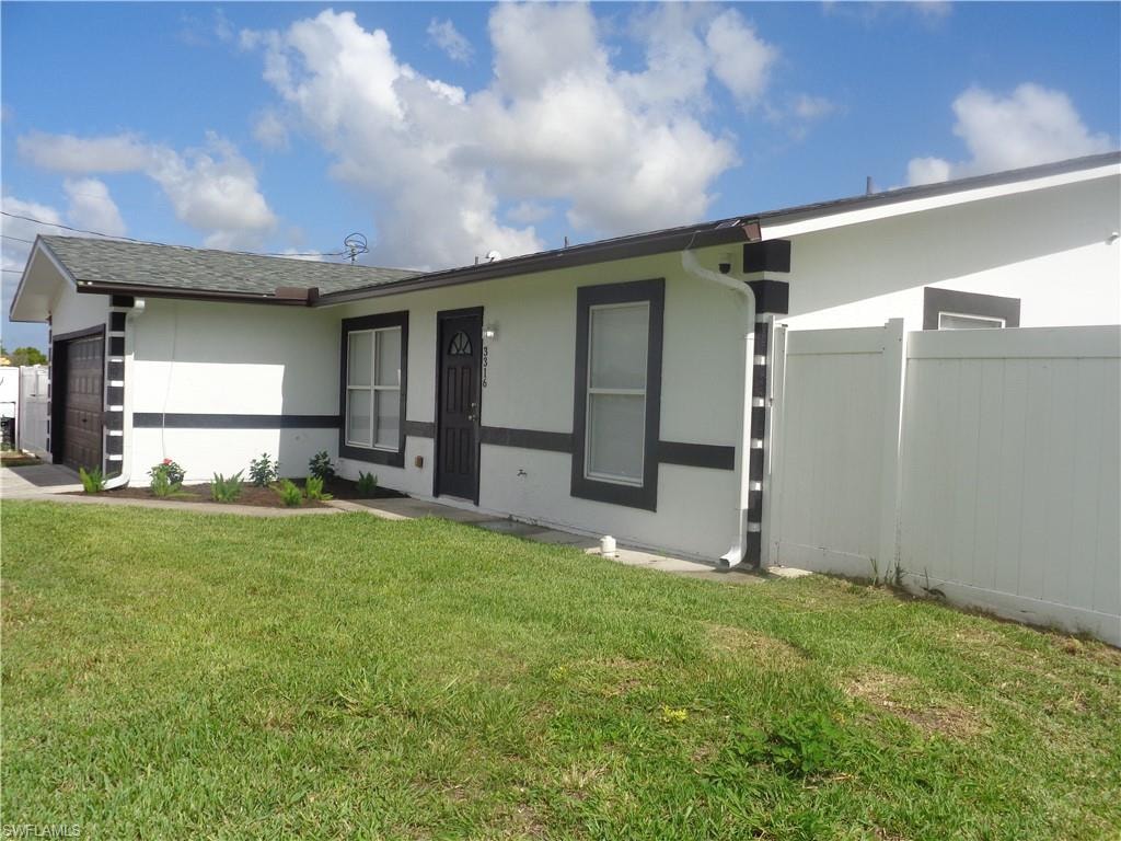 Ranch-style house with a garage, stucco siding, and roof with shingles