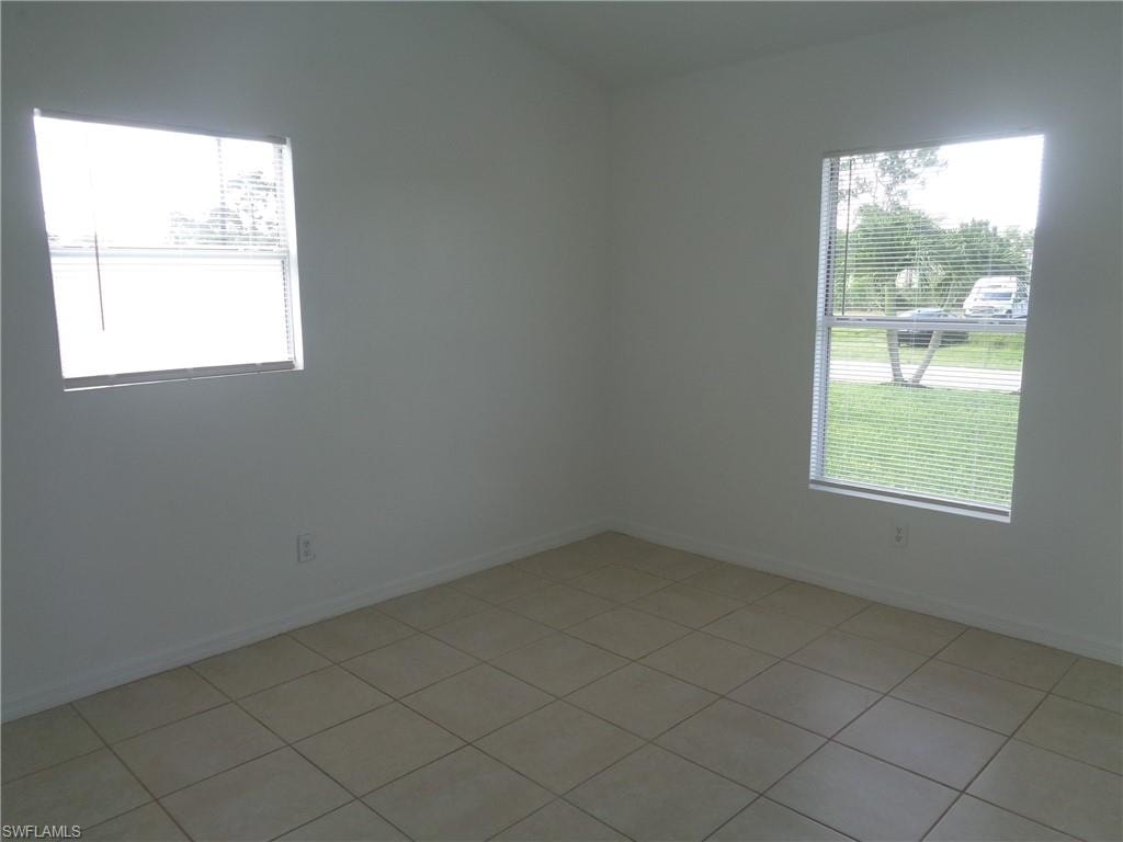 Unfurnished bedroom 1 with light tile patterned floors