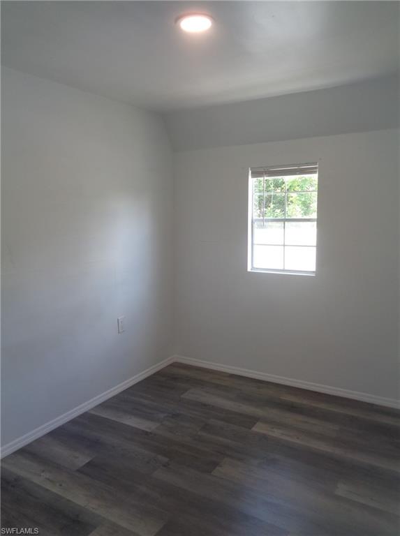 View of unfurnished bedroom of the permitted 2 bed / 1 bath apartment featuring dark wood-style flooring