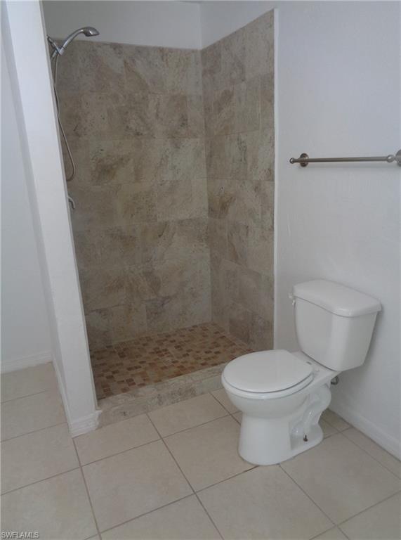 Master bedroom bathroom with tile patterned floors and a shower stall