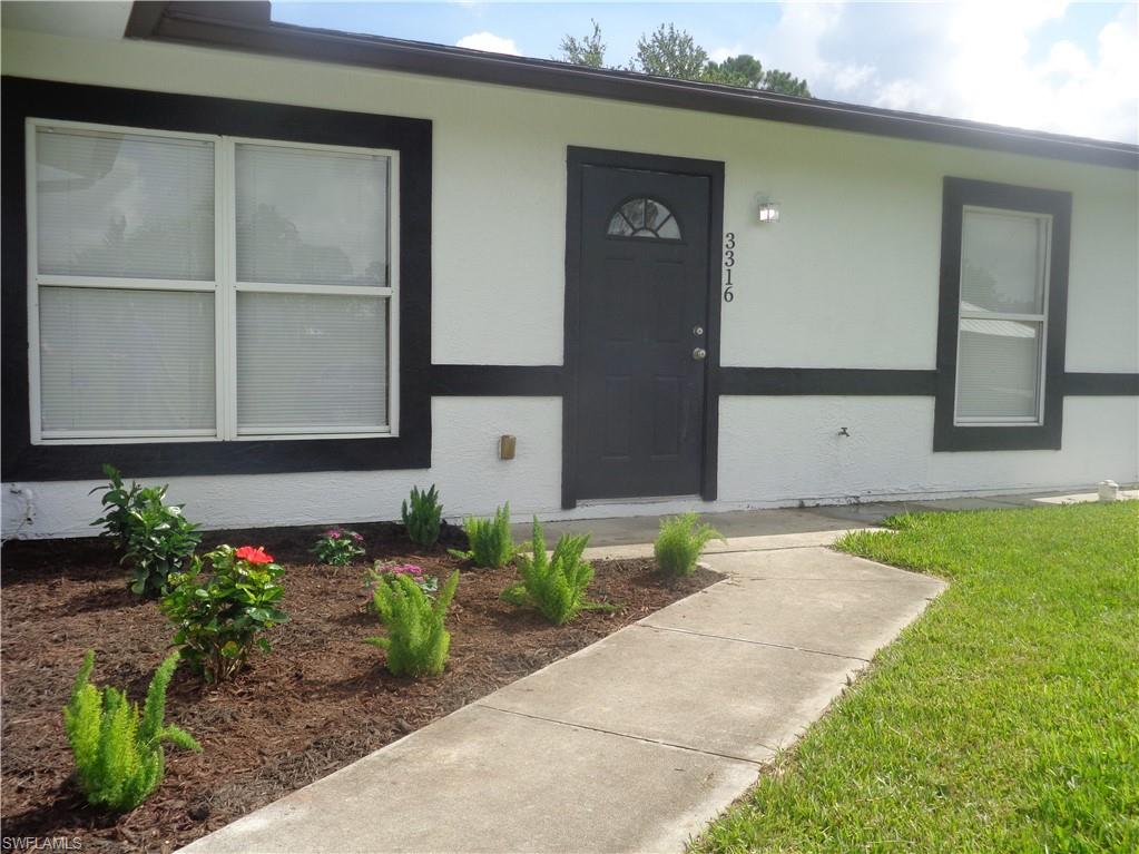 Property entrance with stucco siding