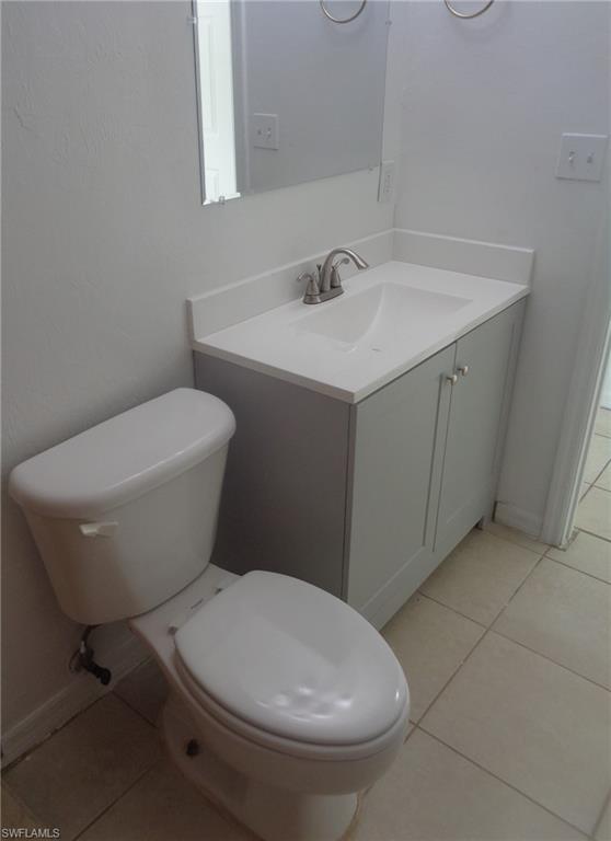 Bathroom with tile patterned floors and vanity