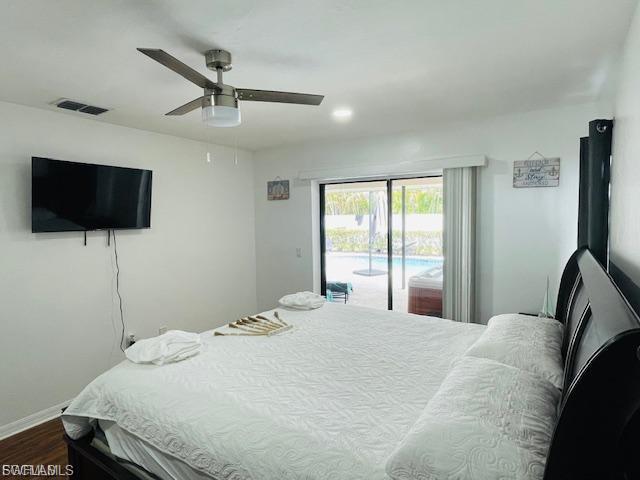 Bedroom featuring access to exterior, a ceiling fan, and dark wood-style floors
