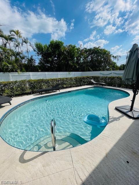 View of swimming pool featuring a fenced backyard