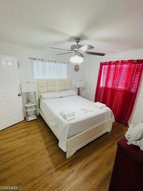Bedroom with wood finished floors and ceiling fan