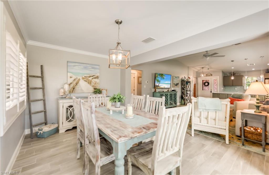 Dining room featuring a chandelier, light wood-style floors, and a ceiling fan