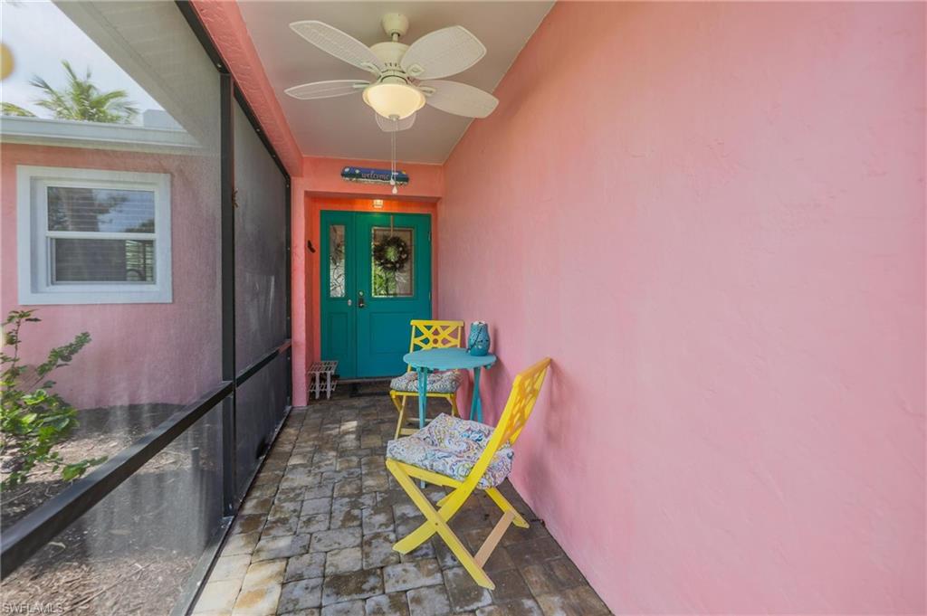 Property entrance featuring stucco siding and a ceiling fan