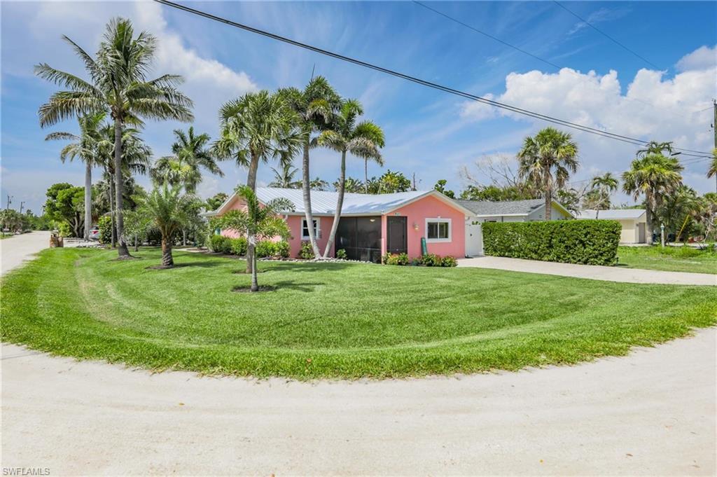 Ranch-style house with concrete driveway, an attached garage, and a front lawn