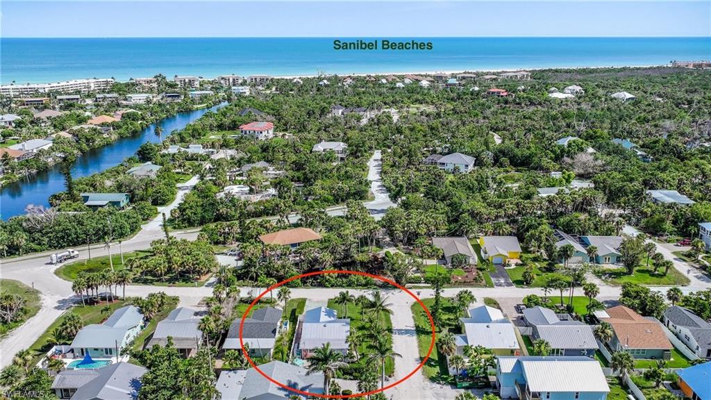 Aerial view of residential area featuring a nearby body of water